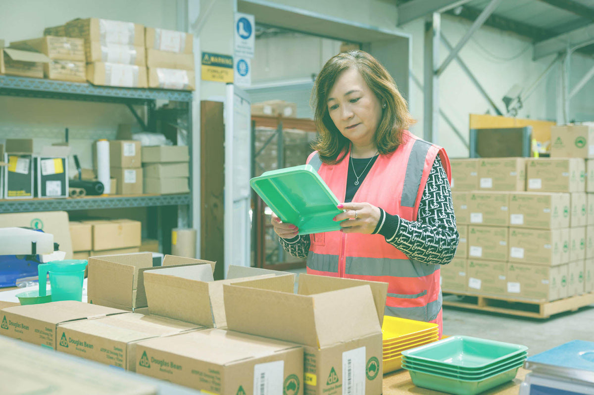 A Douglas Bean Australia team member inspecting an Autoplas tray before packing